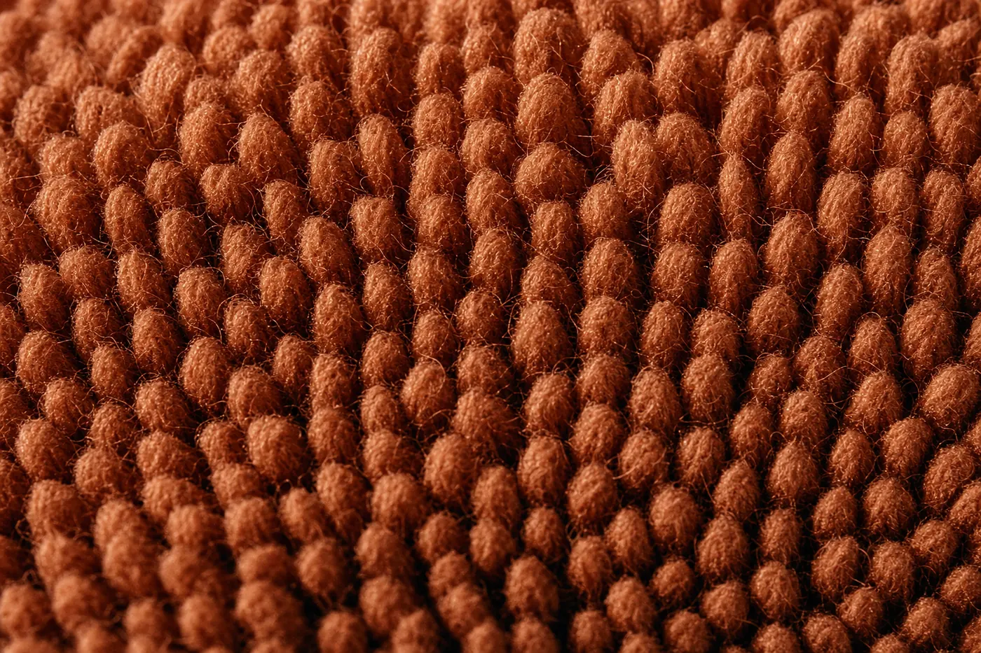 Close-up of dense terracotta wool loops